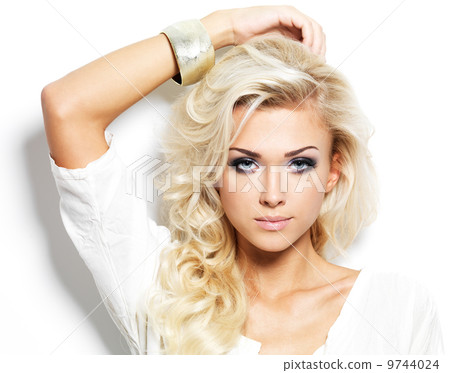 Beautiful blond woman with long curly hair and style makeup. Beautiful blond woman with long curly hair and style makeup. 9744024