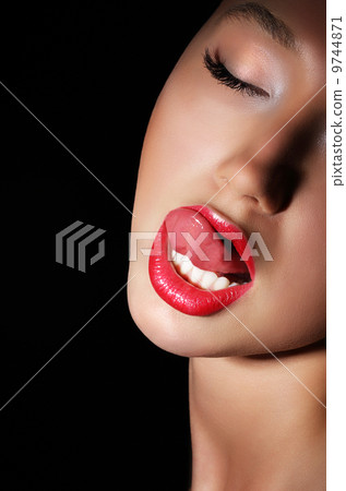 Carnality. Lust. Provocative Woman Licking her Red Sexy Lips. Passion 9744871