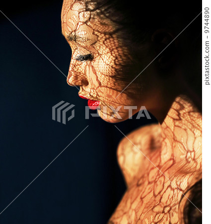 Art Deco. Ethnic Woman's Face with Reflex of Openwork Lace - Fancy Makeup Art Deco. Ethnic Woman's Face with Reflex of Openwork Lace - Fancy Makeup 9744890