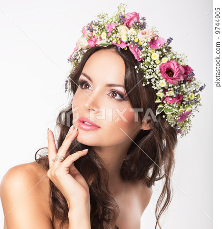 Young Beauty. Woman's Face with Bouquet of Natural Flowers Young Beauty. Woman's Face with Bouquet of Natural Flowers 9744905