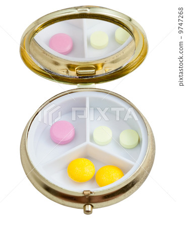 compact pill box with several tablets 9747268