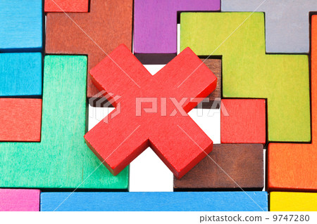 cross shaped piece on multicoloured puzzle cross shaped piece on multicoloured puzzle 9747280