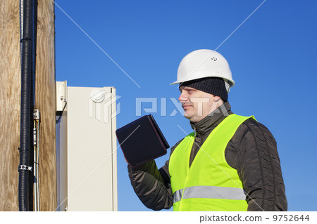 Electrician inspect electric lines technical quality 9752644