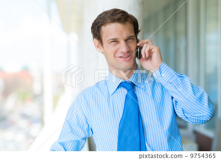 businessman talking on a cell phone businessman talking on a cell phone 9754365