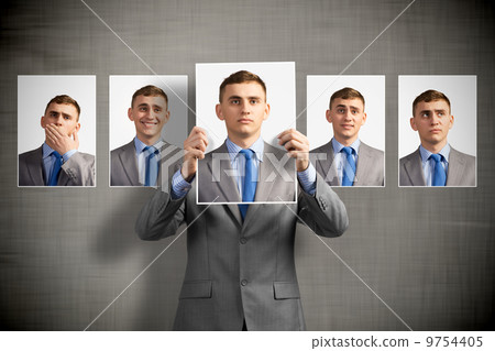 young man holds up a photograph 9754405