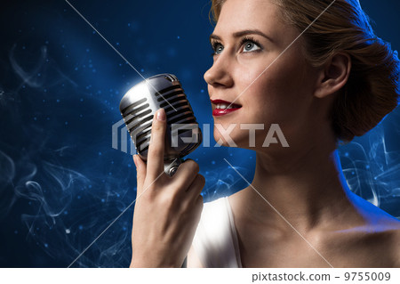 attractive female singer with microphone 9755009