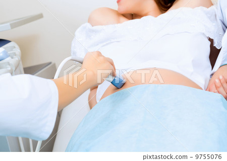 close-up of hands and abdominal ultrasound scanner close-up of hands and abdominal ultrasound scanner 9755076