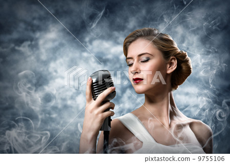 beautiful blonde woman singer with a microphone 9755106