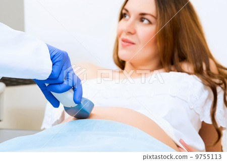 close-up of hands and abdominal ultrasound scanner close-up of hands and abdominal ultrasound scanner 9755113