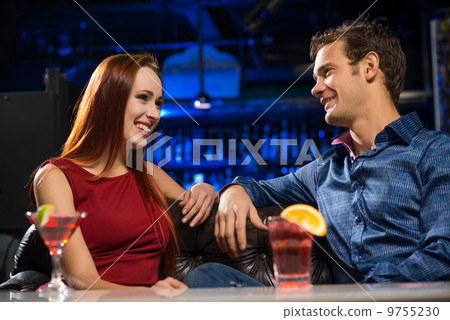 Young couple talking in a nightclub Young couple talking in a nightclub 9755230