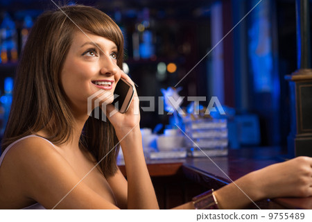 woman with a cup of coffee and cell phone woman with a cup of coffee and cell phone 9755489