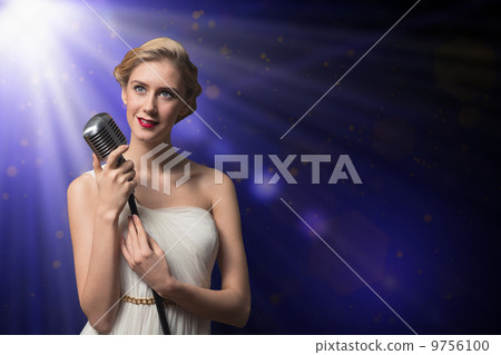 attractive female singer with microphone 9756100