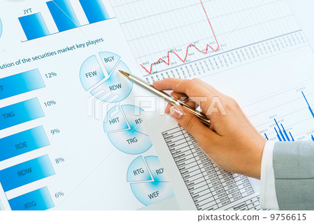 female hand pointing pen on financial charts female hand pointing pen on financial charts 9756615
