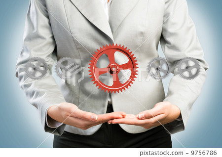 business woman holds up a mechanism of gears business woman holds up a mechanism of gears 9756786