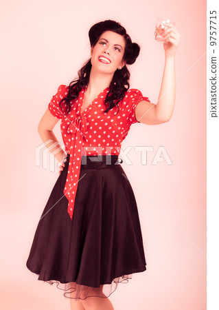 Woman drinking water. Girl with pinup makeup and hairstyle. Retro. Woman drinking water. Girl with pinup makeup and hairstyle. Retro. 9757715