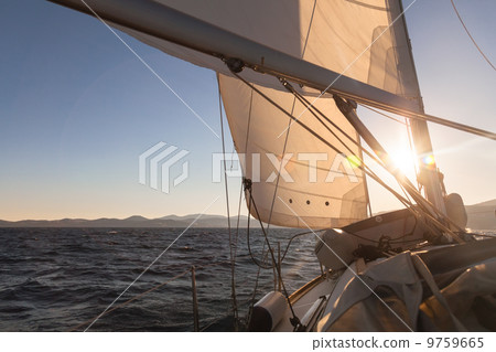 Sailboat at sunset ocean Sailboat at sunset ocean 9759665