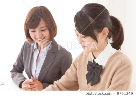 Female student and teacher or private tutor 9761349