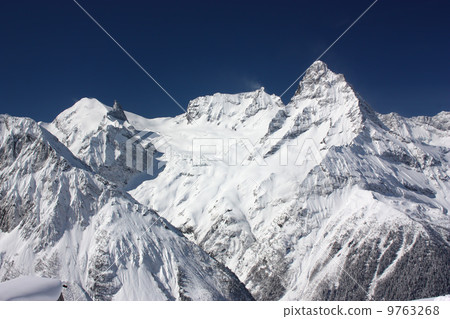 View of ski slopes on a sunny day 9763268