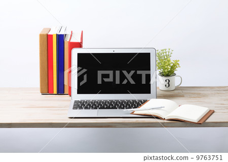 Laptop and notebook on the table 9763751