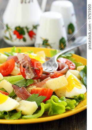 Plate with salad and fork. Plate with salad and fork. 9765900