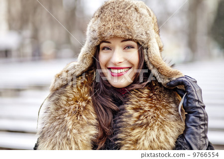 Girl smiling in fur hat and coat Girl smiling in fur hat and coat 9766554