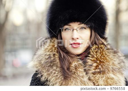 Woman wearing fur hat and glasses 9766558