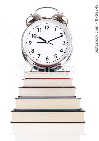 Alarm clock and books isolated on white Alarm clock and books isolated on white 9768249