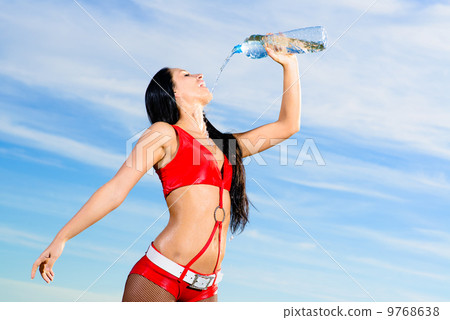 sport girl in red uniform with a bottle of water 9768638