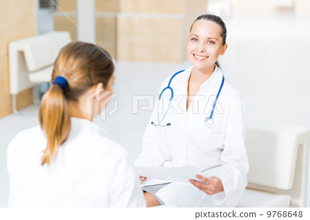 two doctors talking in the lobby two doctors talking in the lobby 9768648
