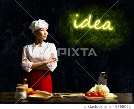 Asian female chef looking at the glowing idea Asian female chef looking at the glowing idea 9768651