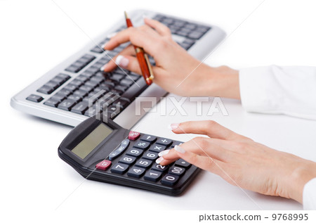 Hands working on the calculator 9768995