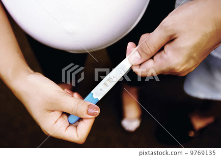 Couple looking at pregnancy test kit result. Couple looking at pregnancy test kit result. 9769135