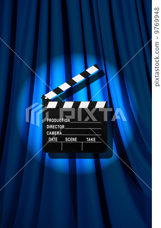 Movie clapper board against curtain 9769948
