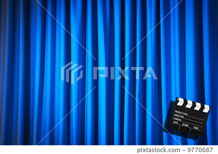 Movie clapper board against curtain 9770087