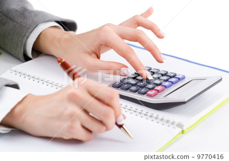 Hands working on the calculator Hands working on the calculator 9770416