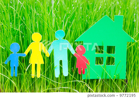 Paper family and house  in grass 9772195
