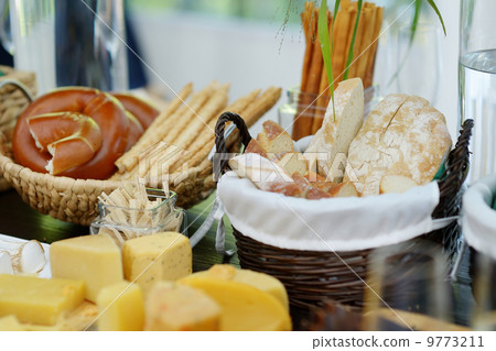 Fresh cheese and bread on a table 9773211