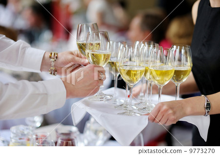 Waitress with dish of champagne glasses 9773270