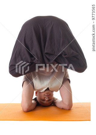 Yoga headstand posing by middle aged man 9773565