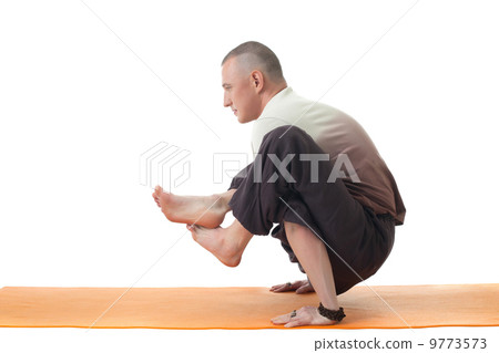 Image of yoga instructor posing in difficult asana Image of yoga instructor posing in difficult asana 9773573