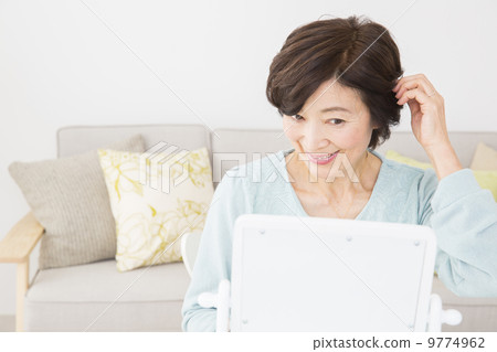 A woman stroking her hair 9774962