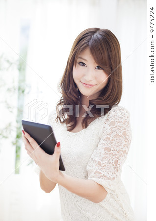 A woman with a tablet A woman with a tablet 9775224