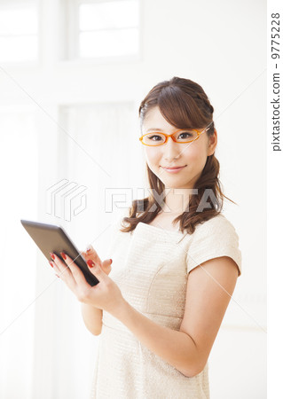 A woman with a tablet A woman with a tablet 9775228