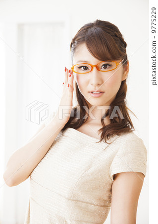 A woman wearing glasses 9775229