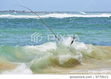 Fisherman in wave 9779022