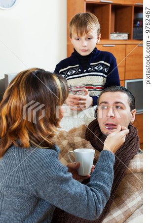 Sick man surrounded by caring wife and son 9782467