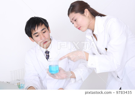 Female researcher showing beaker 9783435