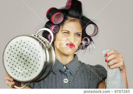 Housewife with a kitchen pot on grey background 9787265
