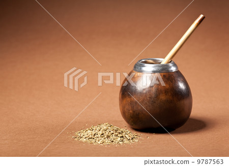 calabash and bombilla with yerba mate isolated on brown backgrou calabash and bombilla with yerba mate isolated on brown backgrou 9787563