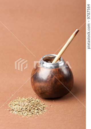 calabash and bombilla with yerba mate isolated on brown backgrou calabash and bombilla with yerba mate isolated on brown backgrou 9787564